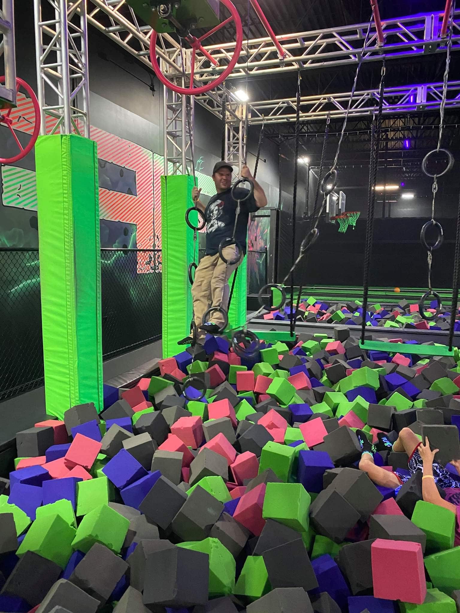 Man Swinging Above Foam Pit